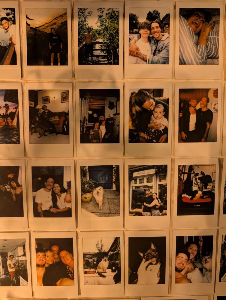 a wall covered in rows of instax mini prints